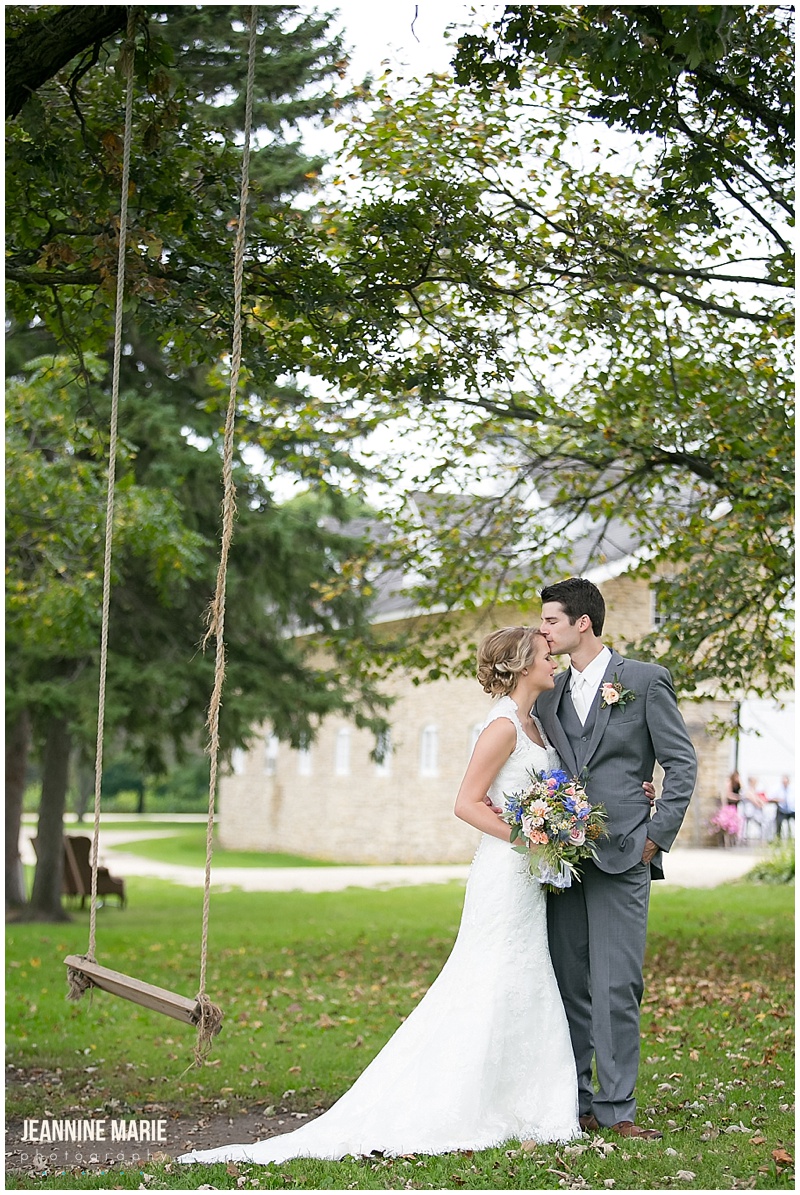 Mayowood Stone Barn, first look, bride, groom, swing, tree, summer, wedding, bridal bouquet, gray suit, wedding dress, wedding gown