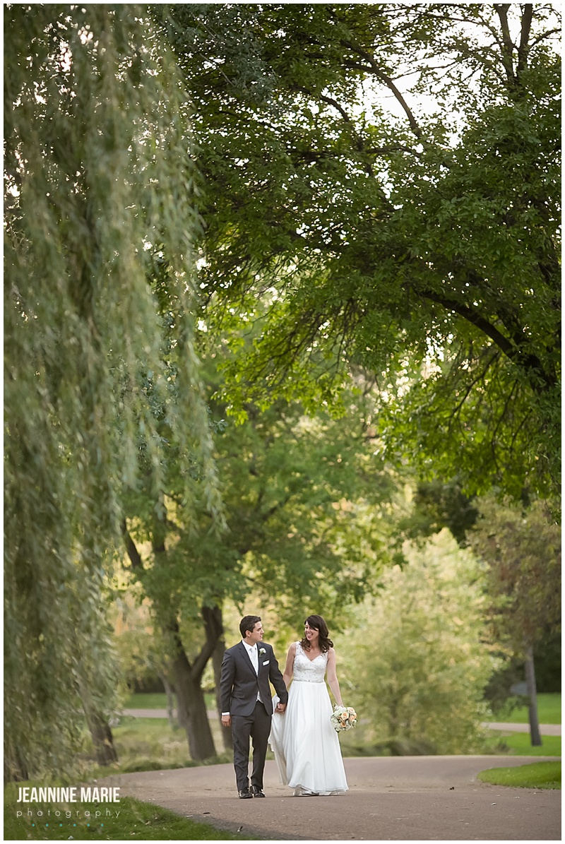 Lakewood Memorial Chapel, trees, sidewalk, bride, groom, holding hands, walking, wedding gown, bridal dress, groom attire, suit