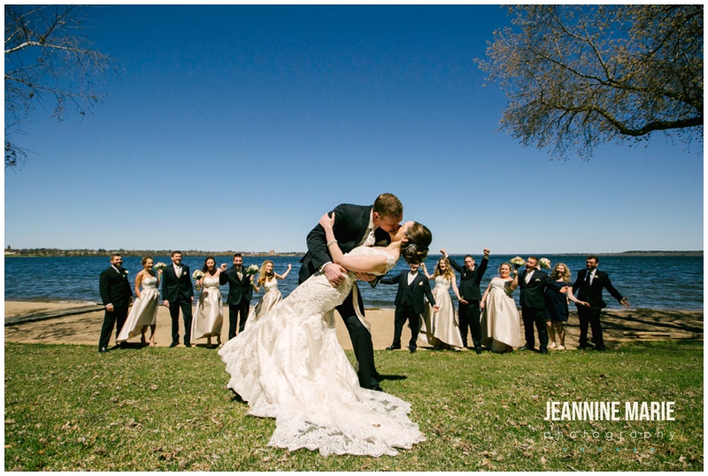 bridal party, bride, groom, dip, kiss, lake, bridal party, bridesmaids, groomsmen, beach, grass, Bemidji wedding, Hampton Inn, Minnesota wedding photographer