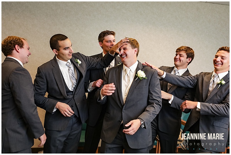 groom, groomsmen, getting ready, laughing, joking around, groomsmen grooming the groom, Shepherd of the Lake Lutheran Church, The Great Hall, Hyatt Place, Instant Request DJ, Avant Decor, Linen Effects, Donatelli's, A Milestone Paper Co., Missy Cole, Unveil Loveliness, MIK Transportation, Eclipse Global Transportation, Jeannine Marie Photography, Minnesota wedding photographer, Saint Paul wedding photographer, summer wedding, lilac wedding, wedding inspiration, church wedding, Saint Paul wedding venues