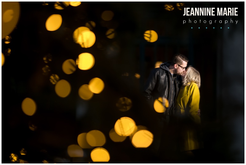 Christmas lights, twinkle lights, couple, kiss, yellow coat, 12welve Eyes Brewing, Union Depot, engaged, engagement session, engagement photos, Saint Paul, Saint Paul engagement, Saint Paul brewery, Saint Paul engagement photos, brewery engagement, brewery engagement photos, winter engagement photos, winter engagement, Jeannine Marie Photography, Saint Paul engagement photographer, Minnesota engagement photographer, engagement photography, Saint Paul engagement photography