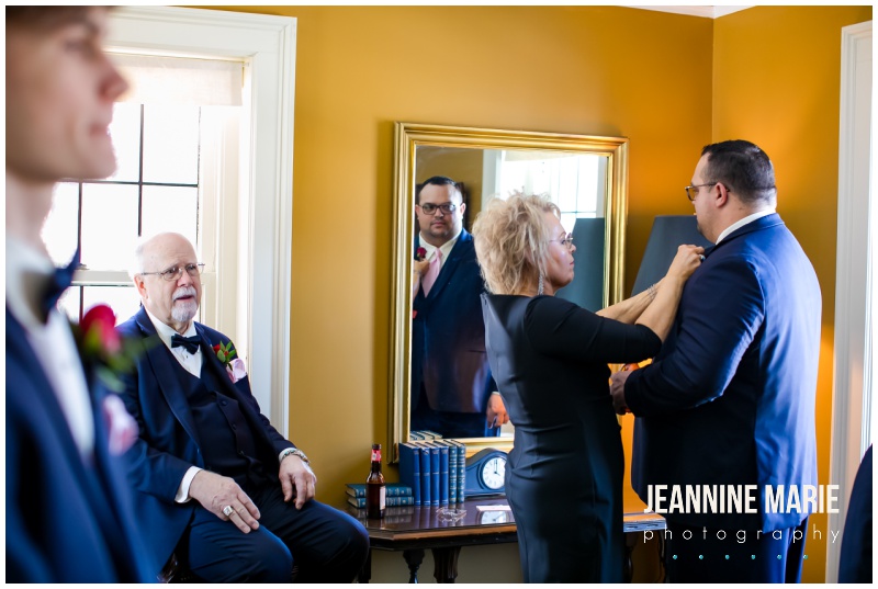 groom, getting ready, mother of the groom, tying bow tie, mirror, St. Paul College Club, Valentine's Day wedding, red roses, red roses wedding, Johnson Jewelers, Dorothy Ann Bakery, Rocket man Entertainment, Jeannine Marie Photography, Minnesota wedding photographer, Saint Paul wedding photographer