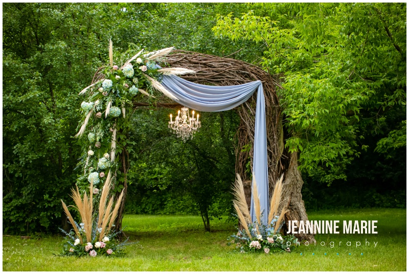ceremony arch, floral decor, draping, chandelier, outdoor ceremony site, Hope Glen Farm, dusty pink wedding, blush wedding, whimsical wedding, dusty blue wedding, floral wedding, romantic wedding, fairytale wedding, Minnesota farm wedding, romantic farm wedding, romantic rustic wedding, outdoor wedding, whimsical wedding floral, Martina Liana wedding gown, Whimsical Tiered Ballgown, Studio B Floral, Bridal Accents Couture, Amy Rachael Makeup Artist, 139 Hair by Heidi, We’ve Got It Covered, Ivory Isle Designs, Miss Sara’s Cakery, Zandolee Media, Jeannine Marie Photography, Saint Paul wedding photographer, Minnesota wedding photographer, Twin Cities wedding photographer, Minnesota Bride, Minnesota outdoor wedding venues, Twin Cities outdoor wedding venues, pavilion wedding, summer wedding