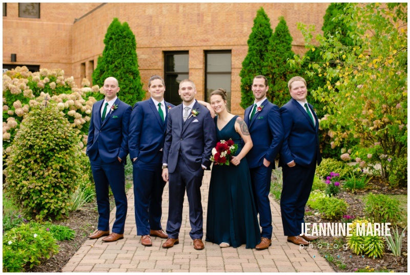 navy suits, navy best woman dress, wedding party portraits, green bridesmaids dresses, navy suits, burgundy wedding floral, hotel wedding, church wedding, fall wedding, covid wedding, pandemic wedding, Jeannine Marie Photography, Minnesota wedding photographer, Lakeville wedding photographer, Bloomington wedding photographer, Twin Cities wedding photographer, Minneapolis wedding photographer, All Saints Catholic Church, Sheraton Bloomington Hotel, Colleen’s Flower Cellar, Queen of Cakes, Instant Request DJ, Minted, Salon Concepts, Ella Rose, Raffine Bridal, Shane Co., Azazie, Men’s Wearhouse