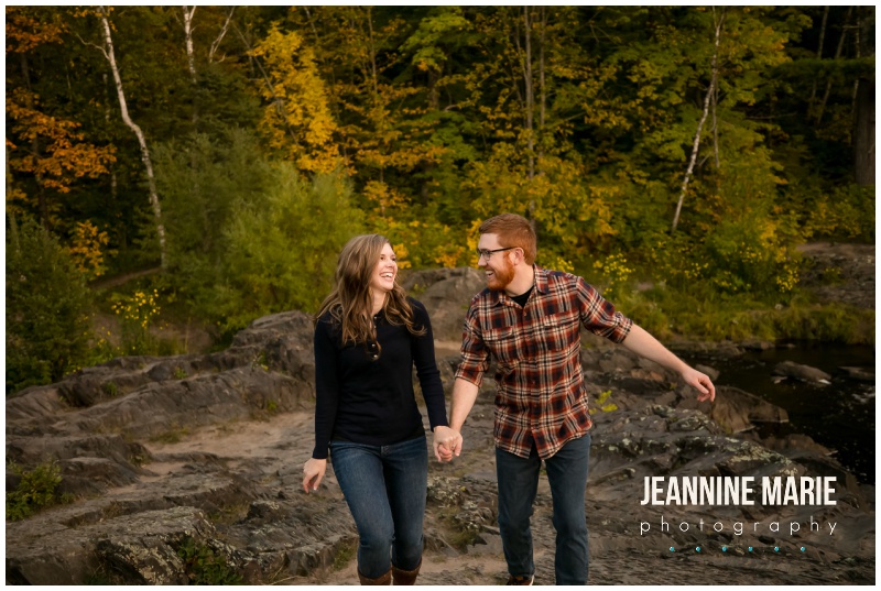 couple, walking, hand in hand, laughing, fall trees, Jay Cooke State Park, fall colors, Minnesota fall, fall engagement session, Northern Minnesota engagement session, Duluth engagement session, Jeannine Marie Photography, Northern Minnesota engagement photographer, Duluth engagement photographer, Minnesota engagement photographer, Twin Cities engagement photographer, Duluth wedding photographer, Minnesota wedding photographer, fall engagement portraits, nature engagement portraits, outdoor engagement portraits