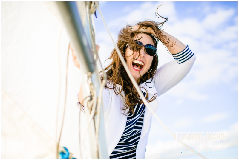 laughing, hair flying, woman, sunglasses, sailboat outfit, sailboat engagement session, nautical engagement session, lake engagement session, sailboat couples portraits, nautical couples, Minnesota engagement session, Minnesota couples portraits, boat portrait session, Jeannine Marie Photography, Minnesota wedding photographer