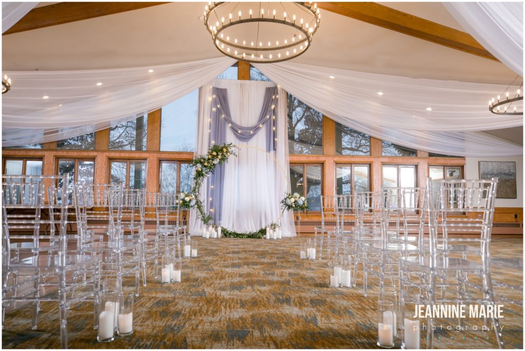 ceremony backdrop, aisle design, draping, gold round arch, chandeliers, candles, greenery, floral arch, dusty blue wedding, yellow wedding, winter wedding, spring wedding, Minnesota weddings, Majestic Oaks Golf Club, Studio B Floral, We've Got It Covered, 139 Hair by Heidi, Queen of Cakes, Milbern Clothing Co, Hunt Wright Design Co, Marie Wulff, Jeannine Marie Photography, Minnesota wedding photographer, Saint Paul wedding photographer, Minneapolis wedding photographer, Twin Cities wedding vendors, Minnesota wedding vendors, wedding reception, wedding ceremony, indoor wedding, wedding inspiration