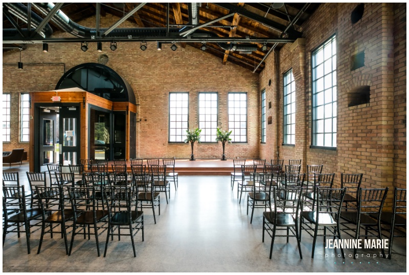 ceremony site, black chairs, windows, indoor wedding, black and hunter green wedding, hunter green wedding, Minneapolis venue, unique Twin Cities wedding venues, The Essence Event Center, Keyed Up Events, Jeannine Marie Photography, Studio B Floral Designs, Epitome Papers, Festivities, Chowgirls Catering, 139 Hair by Heidi, LHN Beauty, The Wedding Shoppe, Wtoo by Watters, The Jeweler Ryan, SuitShop, Jim’s Formalwear, GiftedGroom, Emily Theisen