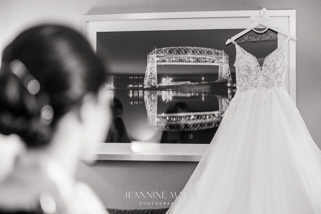 getting ready photo of bride admiring her wedding dress at the glensheen mansion photographer Jeannine Marie Photography