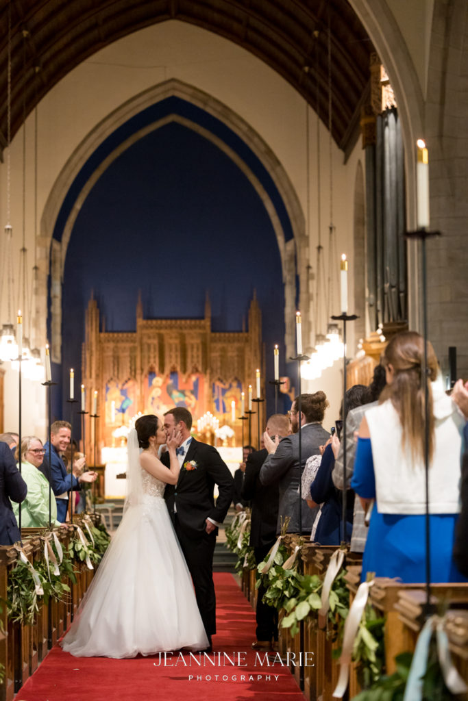 hollywood kiss after the wedding ceremony halfway down the aisle in a duluth minnesota church