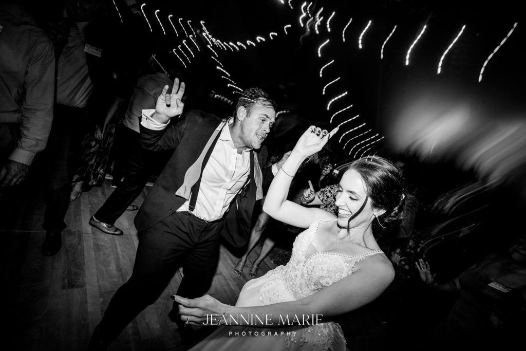 Portrait of bride and groom dancing at Duluth wedding photographed by photographer Jeannine Marie Photography