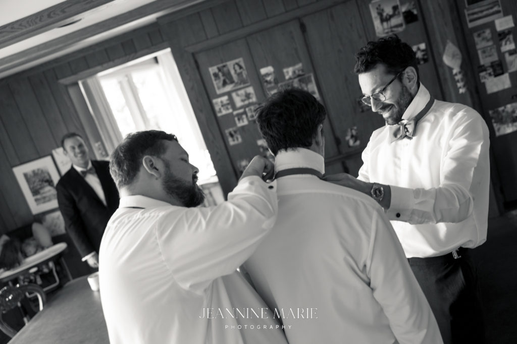 groom getting ready with groomsmen at a duluth wedding photographed by Jeannine Marie Photography