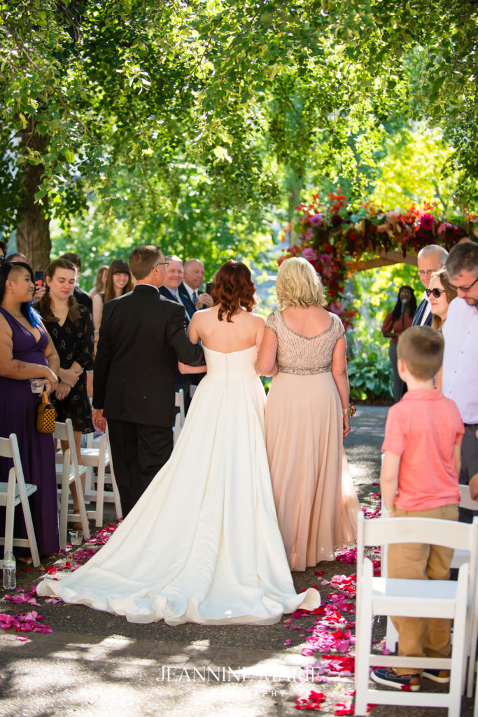 back of wedding dress during procession at outdoor wedding ceremony in mpls, Nicollet Island Pavilion Wedding